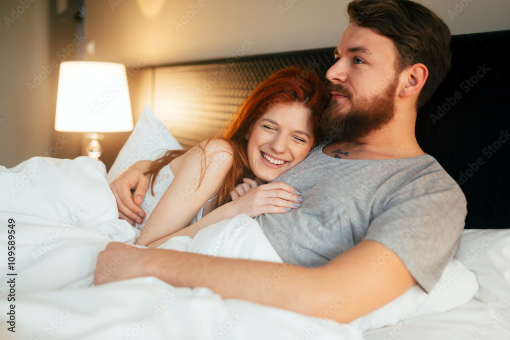 Sensual couple in bed being romantic Sensual couple in bed being romantic