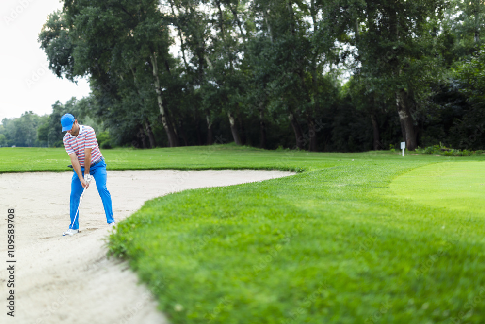 Golfer taking a bunker shot