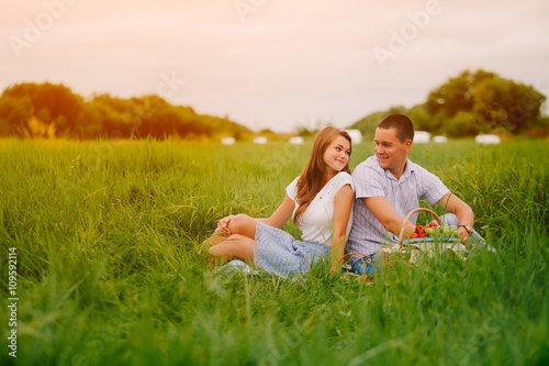 Couple on sunset picnic. Copyspace in right.