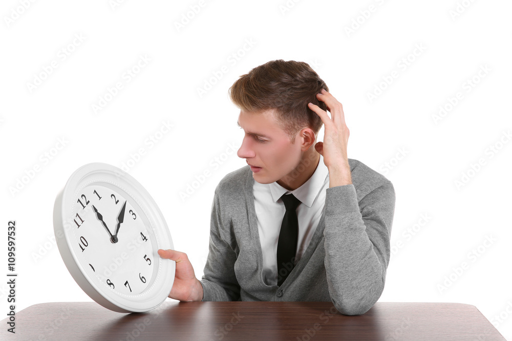 Handsome young man holding clock, isolated on white Handsome young man holding clock, isolated on white