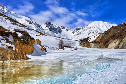 Trail on frozen river in mountains of Eastern Sayan