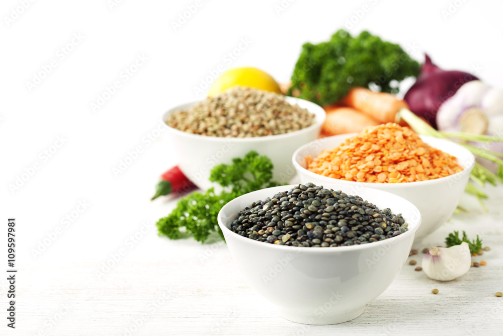 Bowls of assorted dried lentils with vegetables Bowls of assorted dried lentils with vegetables