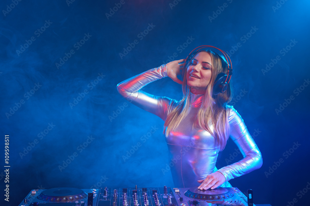 DJ girl on decks at the party