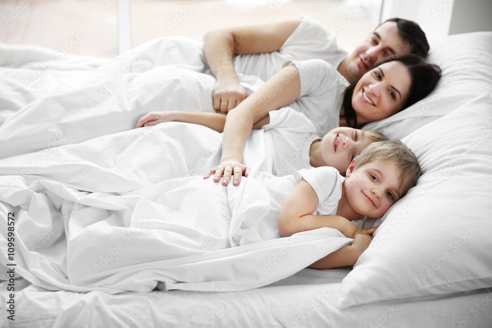 Fototapeta premium Family awakening in bed, closeup