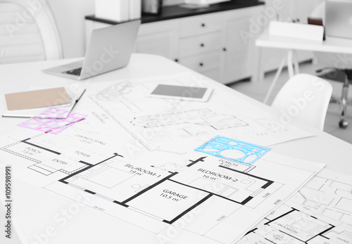 Table of architect with drafts and clipboard in the office