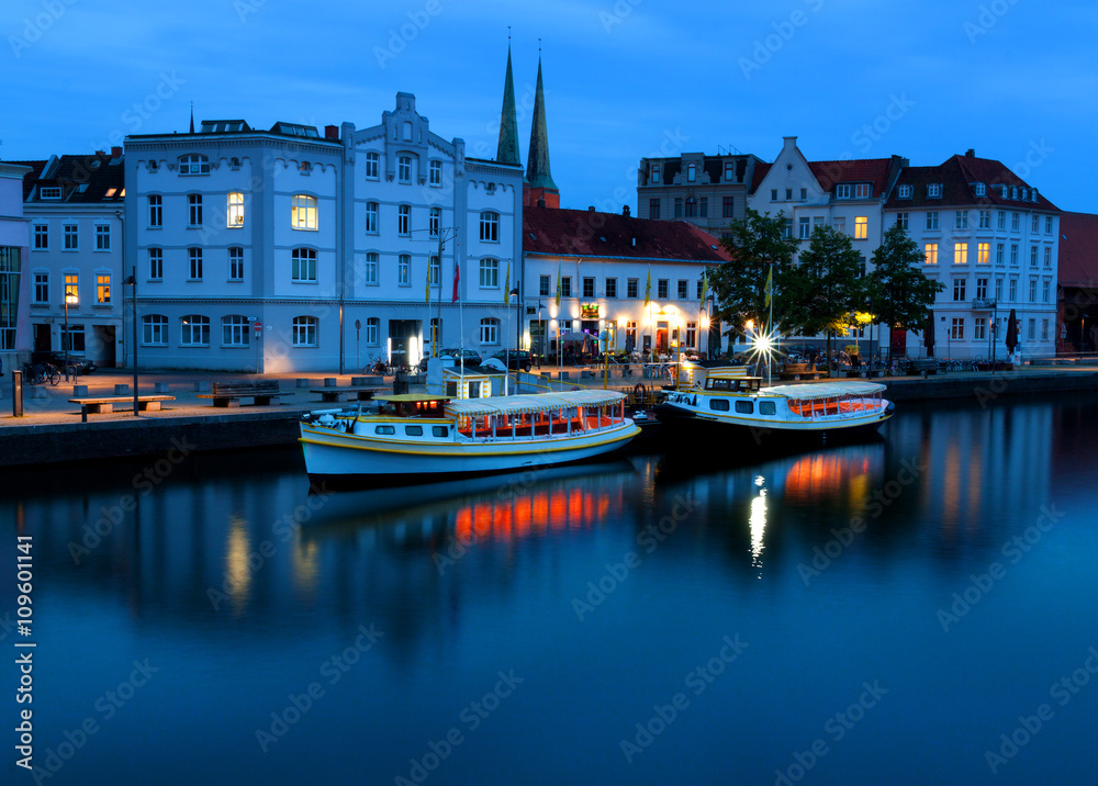 Fototapeta premium Lubeck at night with Untertrave river boardwalk