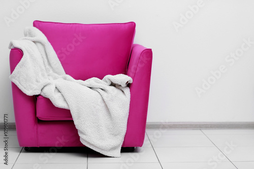 Pink armchair with blanket ...
