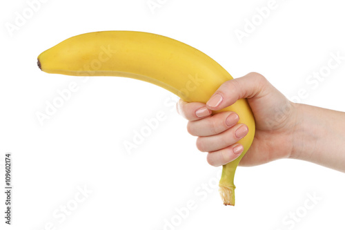 Female hand holding banana isolated on white