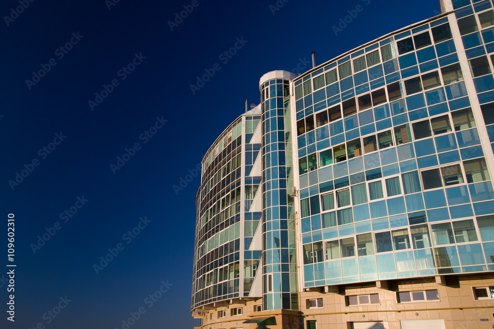 The photo of multistory building, shot on the wide lens with PL filter, in the sunset light The photo of multistory building, shot on the wide lens with PL filter, in the sunset light