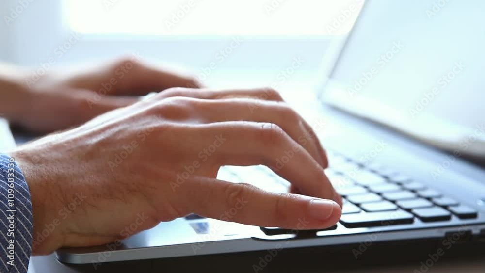 Close up of hands typing on laptop keyboard Close up of hands typing on laptop keyboard