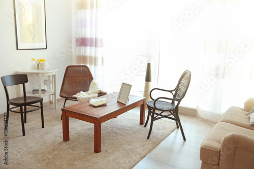 Modern living room interior. Different kinds of chair around table.