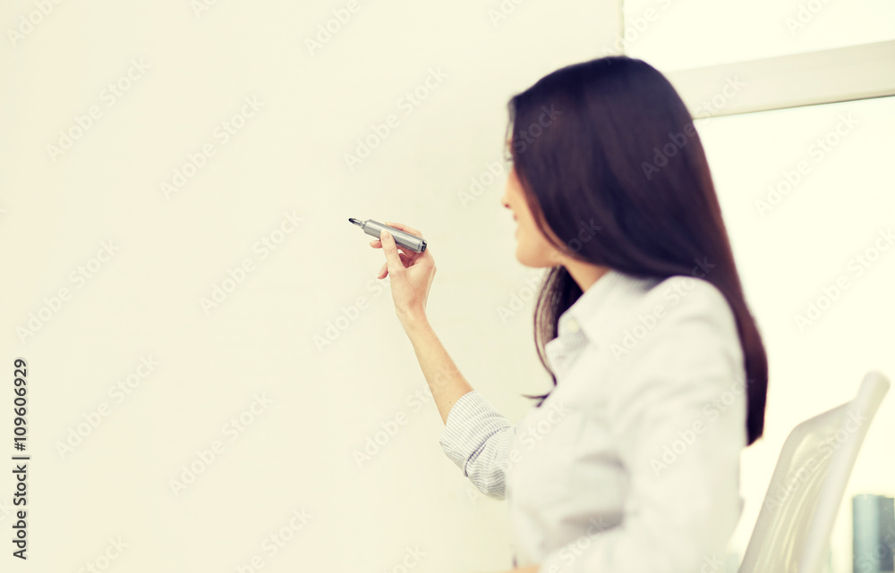 happy woman with marker writing on whiteboard happy woman with marker writing on whiteboard
