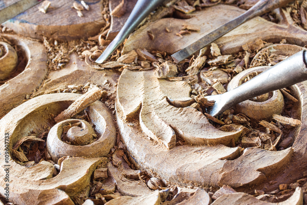 a wood carvings, tools and processes work closeup a wood carvings, tools and processes work closeup