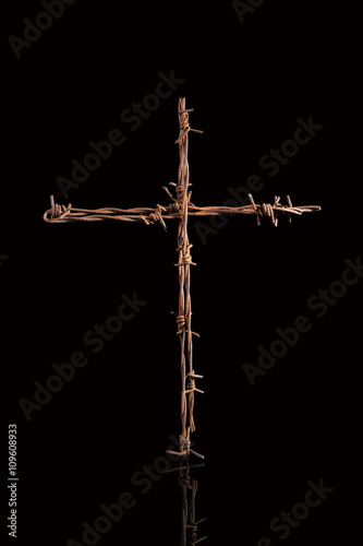 Rusty barbwire cross.