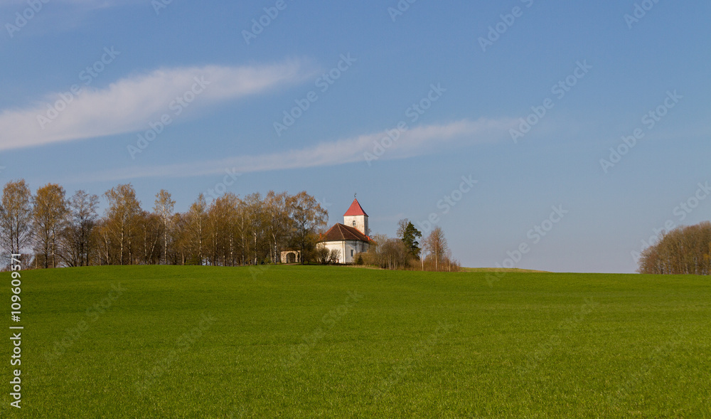 Small church on a field.