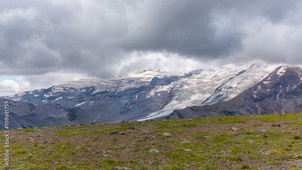 Rocky slopes in the mountains. Amazing view at the peaks which rose against the cloud sky. Path on the tops of mountains. BURROUGHS MOUNTAIN TRAIL, Sunrise Area, Mount Rainier National Park