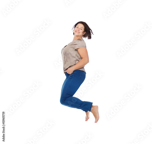 smiling happy plus size woman jumping high in air