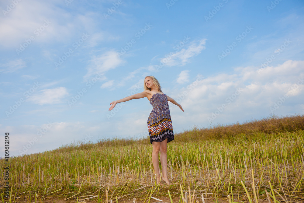 beautiful blonde walks into the field. portrait of a beautiful blonde in a field beautiful blonde walks into the field. portrait of a beautiful blonde in a field