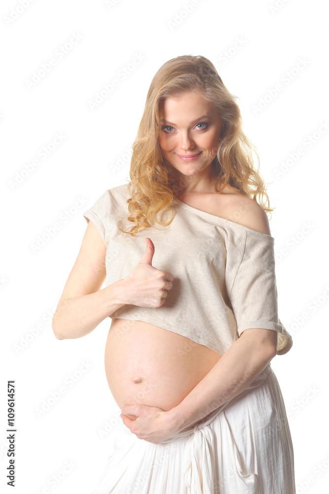 pregnant woman caressing her belly over white background. Positive pregnant woman shows thumb pregnant woman caressing her belly over white background. Positive pregnant woman shows thumb