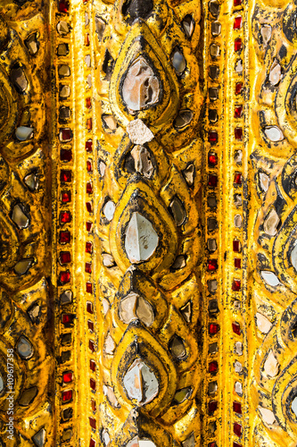 Golden mosaic ornament on the wall of a Buddhist temple in Bangk