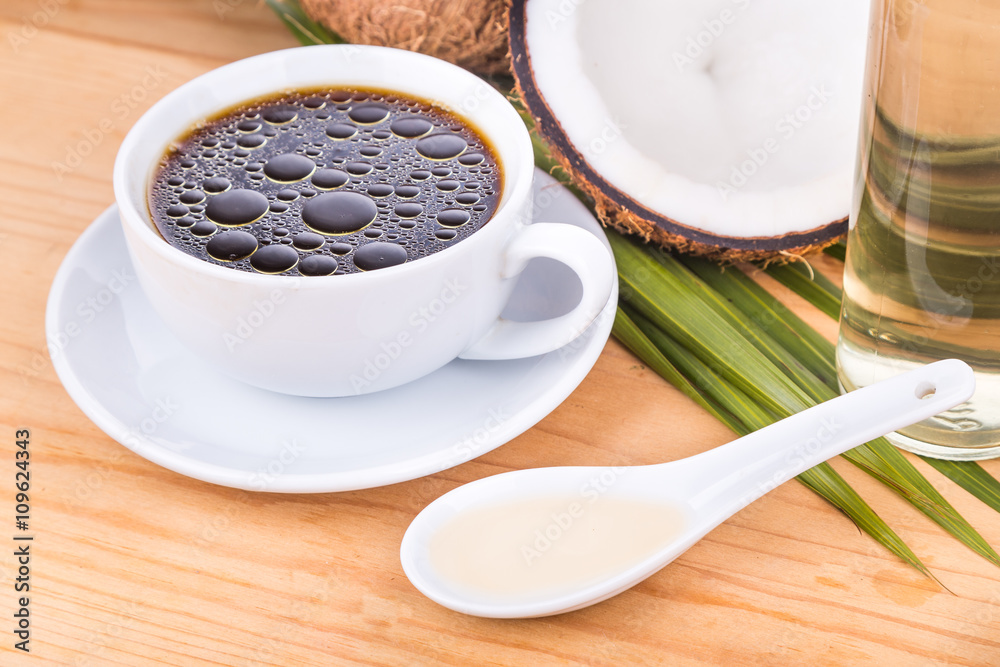 Closeup of bulletproof coffee with cold pressed extra virgin coconut oil on wooden table, part of ketogenic diet Closeup of bulletproof coffee with cold pressed extra virgin coconut oil on wooden table, part of ketogenic diet