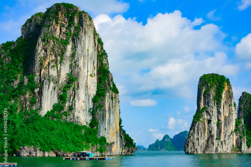 Rock islands near floating village in Halong Bay