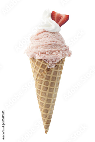 strawberry ice cream in cone with slice of strawberry on top