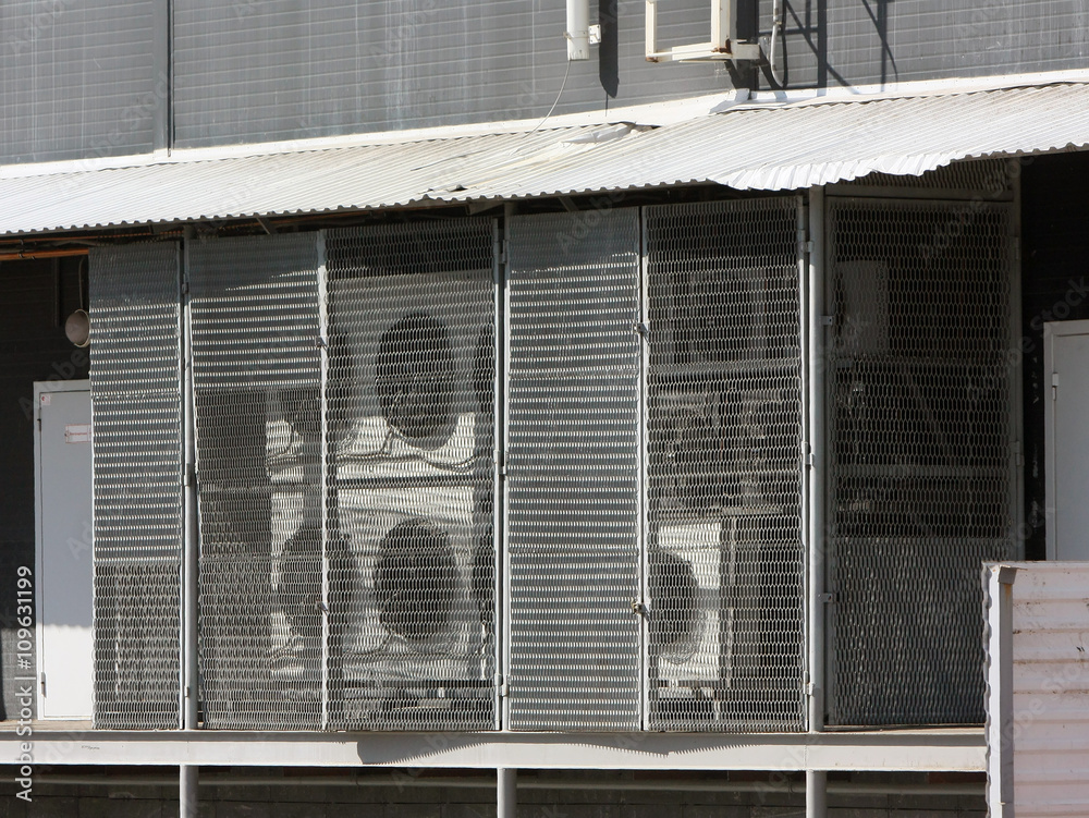 Fototapeta premium Many air conditioners at the shopping center. The ventilation system of protective netting.