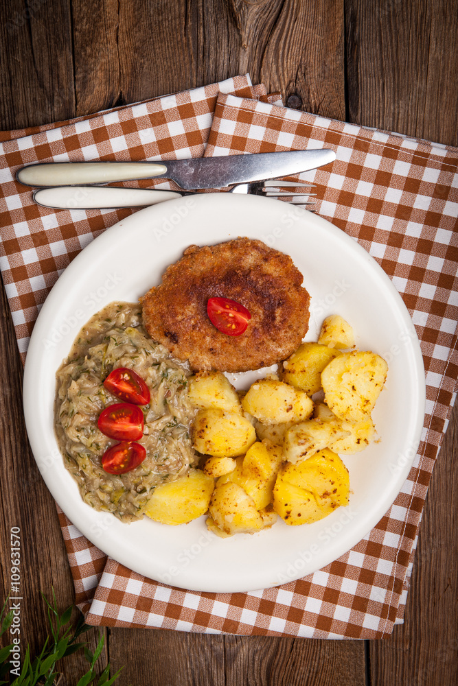Delicious meal of minced meat cutlet, potatoes and fried cabbage Delicious meal of minced meat cutlet, potatoes and fried cabbage