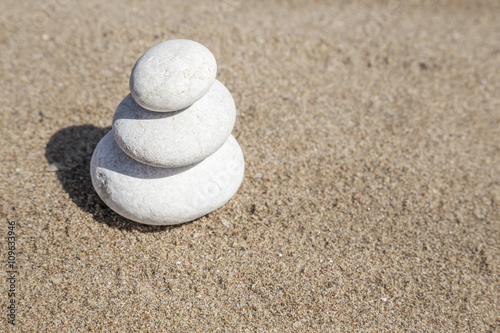 stack of pebble stones on balance on sand