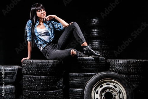 Woman sitting on a tires