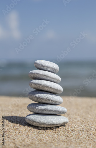stack of pebble stones on balance on sand