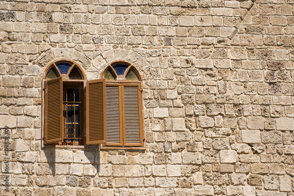 two arch windows on a stone wall two arch windows on a stone wall