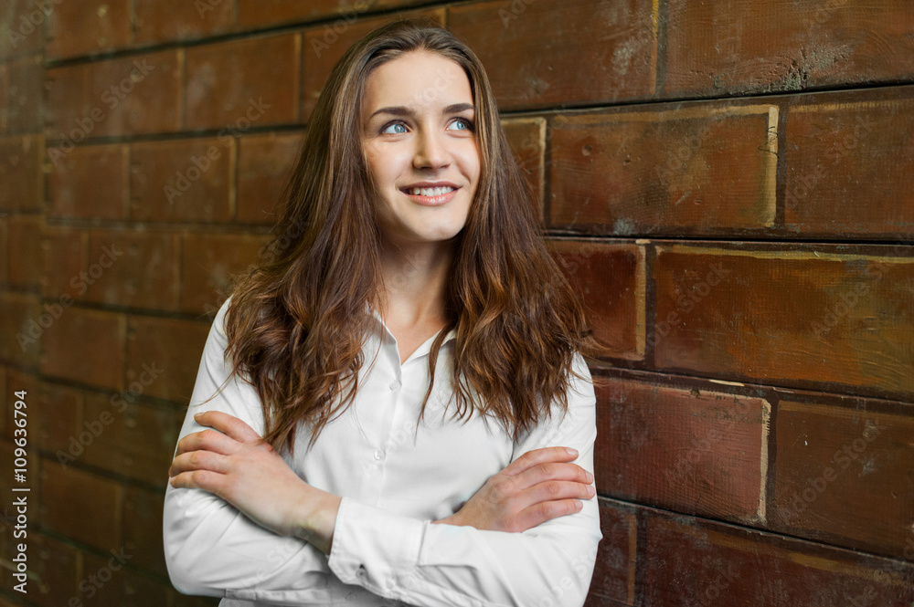 Pretty female girl in white shirt on brick background Pretty female girl in white shirt on brick background