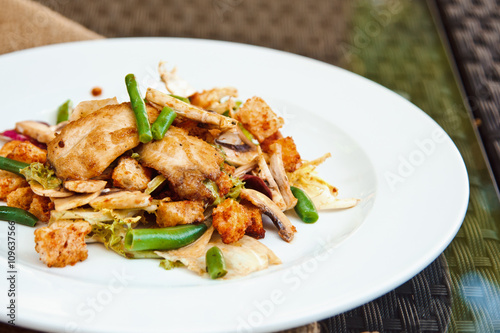 Beautiful mixed salad with chicken fillet, crispy croutons, asparagus and mushrooms in original seasoning