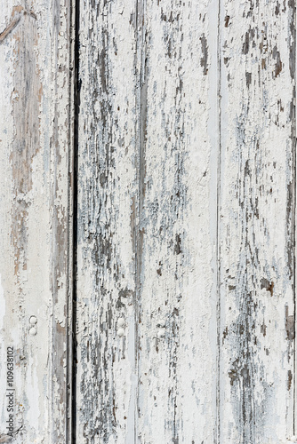 Weathered white wooden background with paint chipped and peeling.