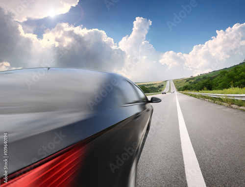 Motion blurred car on asphalt road