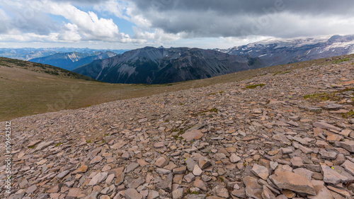 Rocky slopes in the mountains. Amazing view at the peaks which rose against the cloud sky. Path on the tops of mountains. BURROUGHS MOUNTAIN TRAIL, Sunrise Area, Mount Rainier National Park photo