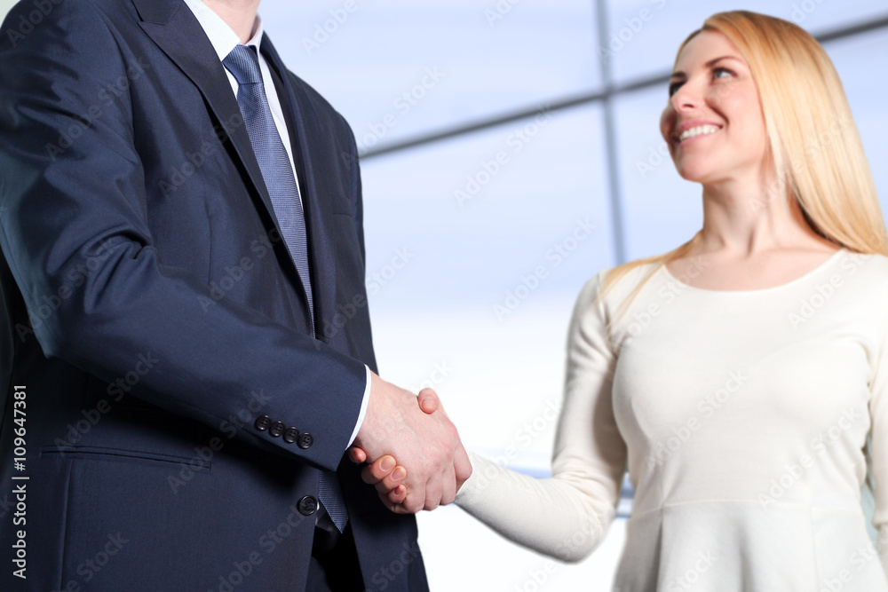 The Close-up image of a firm handshake between two colleagues in