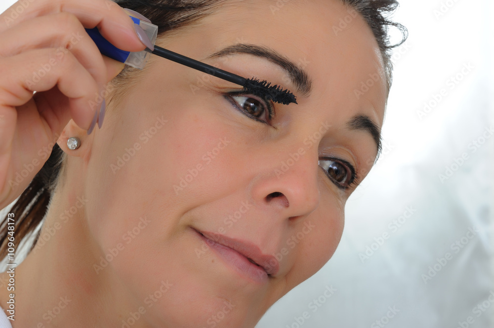 middle aged woman put mascara