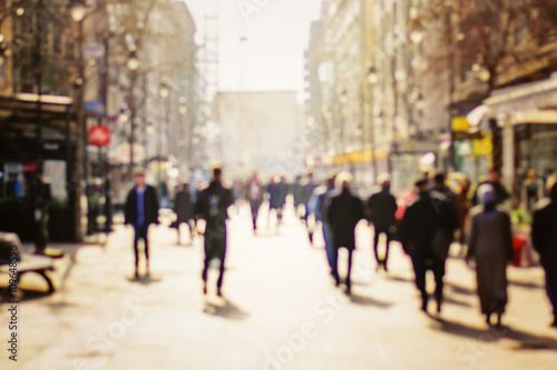 Blurred background. Blurred people walking through a city street