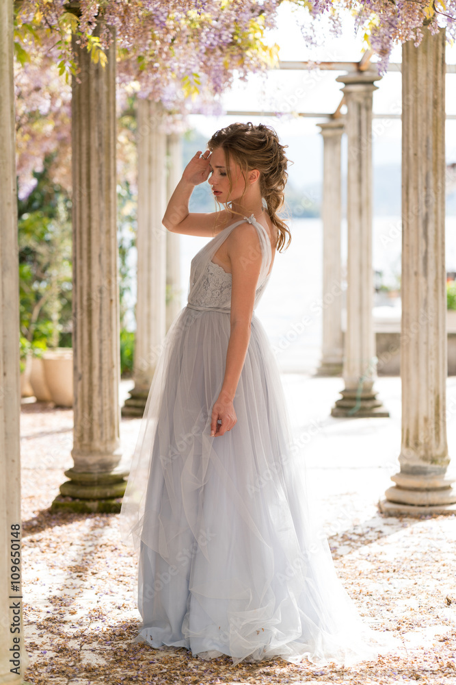 young bride in a wedding dress poses on the terrace young bride in a wedding dress poses on the terrace