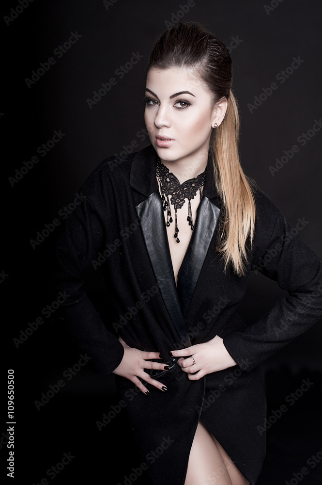 Beautiful woman with professional make up wearing jacket over dark background. Hairstyle, studio shot Beautiful woman with professional make up wearing jacket over dark background. Hairstyle, studio shot