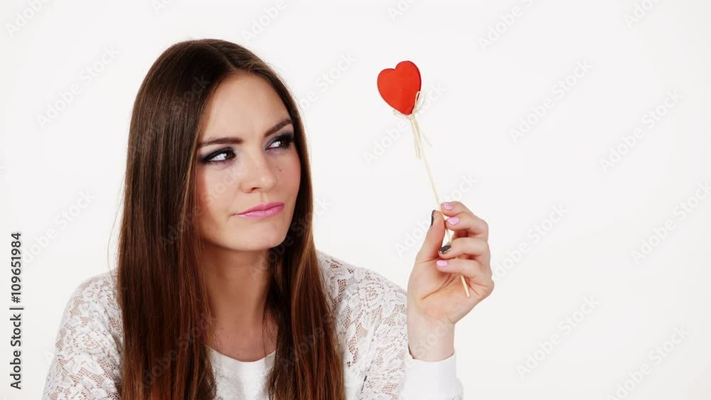 Woman holding red heart love symbol thinking 4K Woman holding red heart love symbol thinking 4K