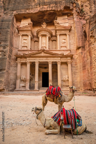 Close-up front view of the famous Al-Khazneh (aka Treasury) with camels resting next to it in the ancient city of Petra (Jordan)