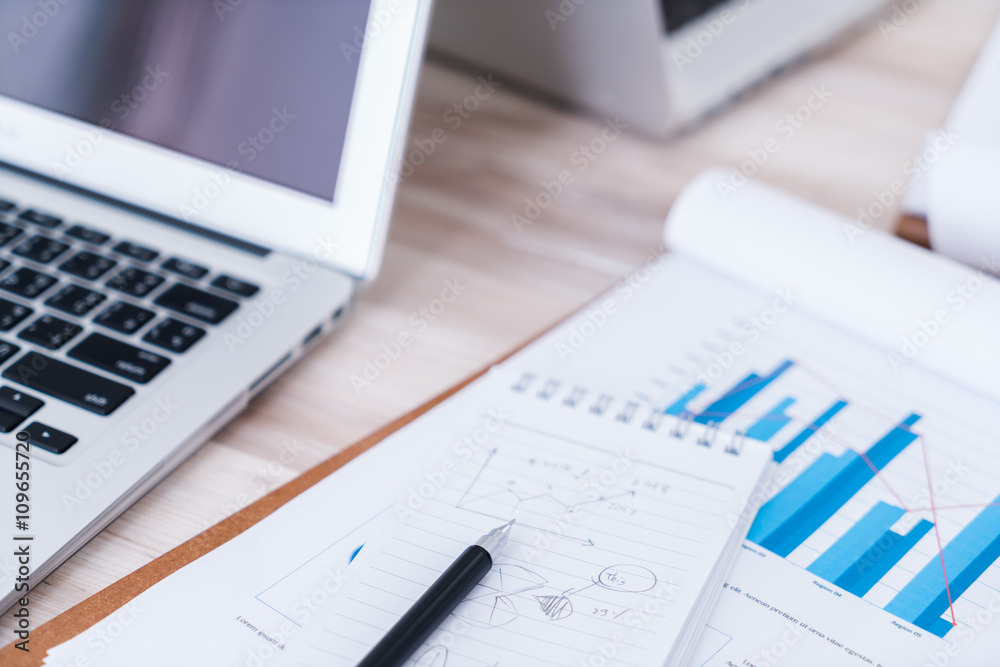 Financial charts on the table with laptop.. Financial charts on the table with laptop..