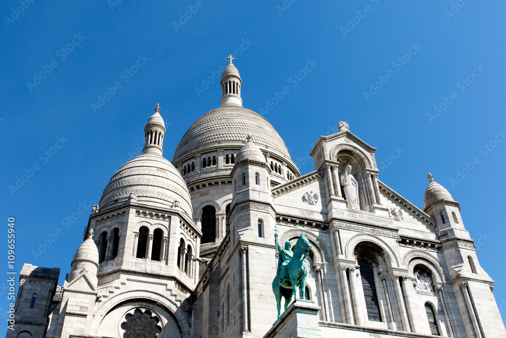 Color DSLR image of Basilica of the Sacre Couer, Montmartre, Paris, France. Catholic church cathedral is popular Europe tourist destination. Horizontal with copy space for text.
