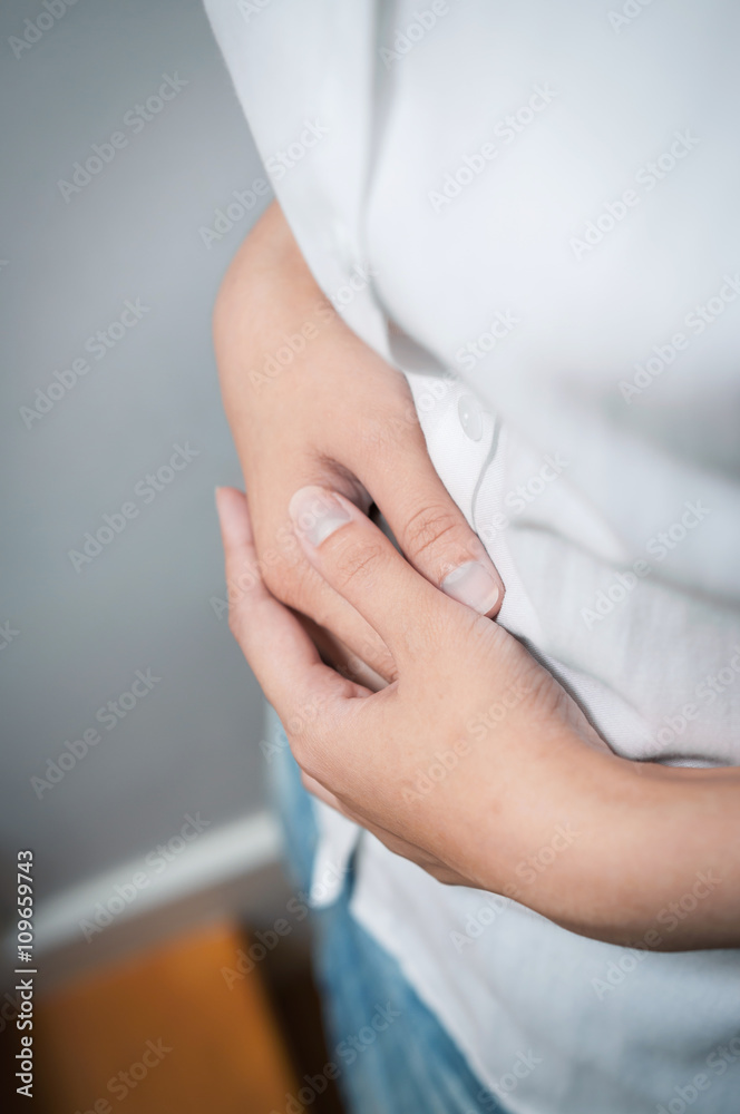 Closeup of hands of  woman have a stomachache.