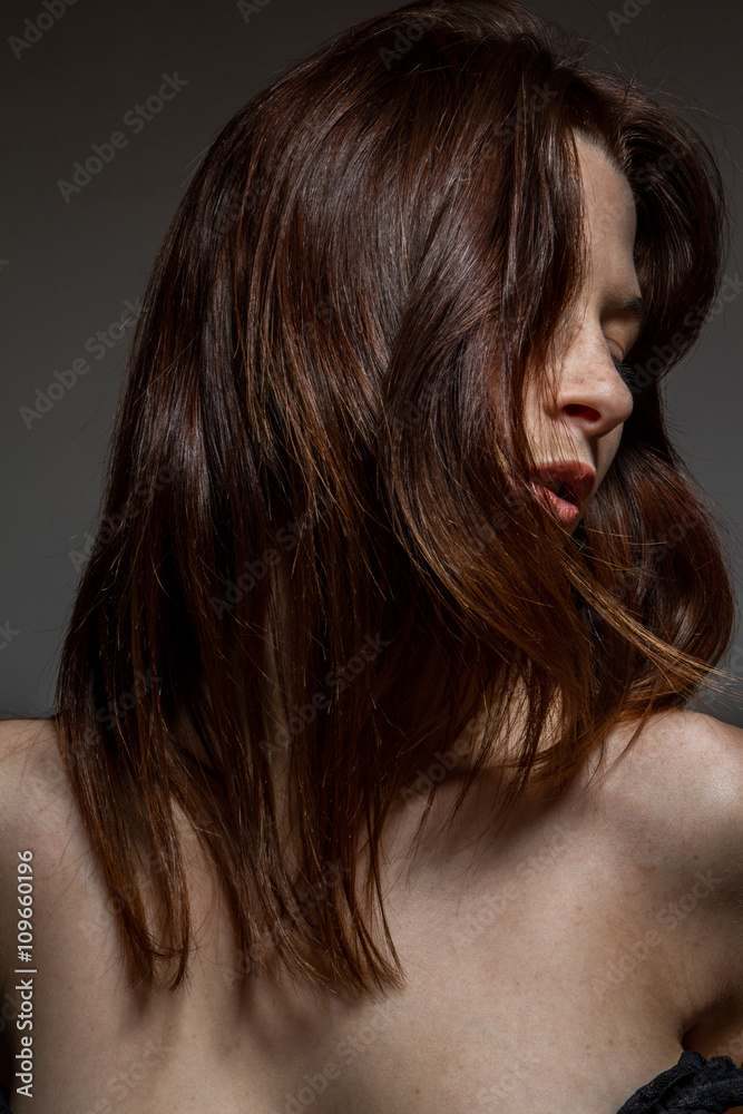Fototapeta premium Closeup of a freckled woman, disheveled