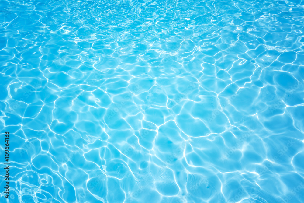 Blue and bright water with sun reflection in swimming pool